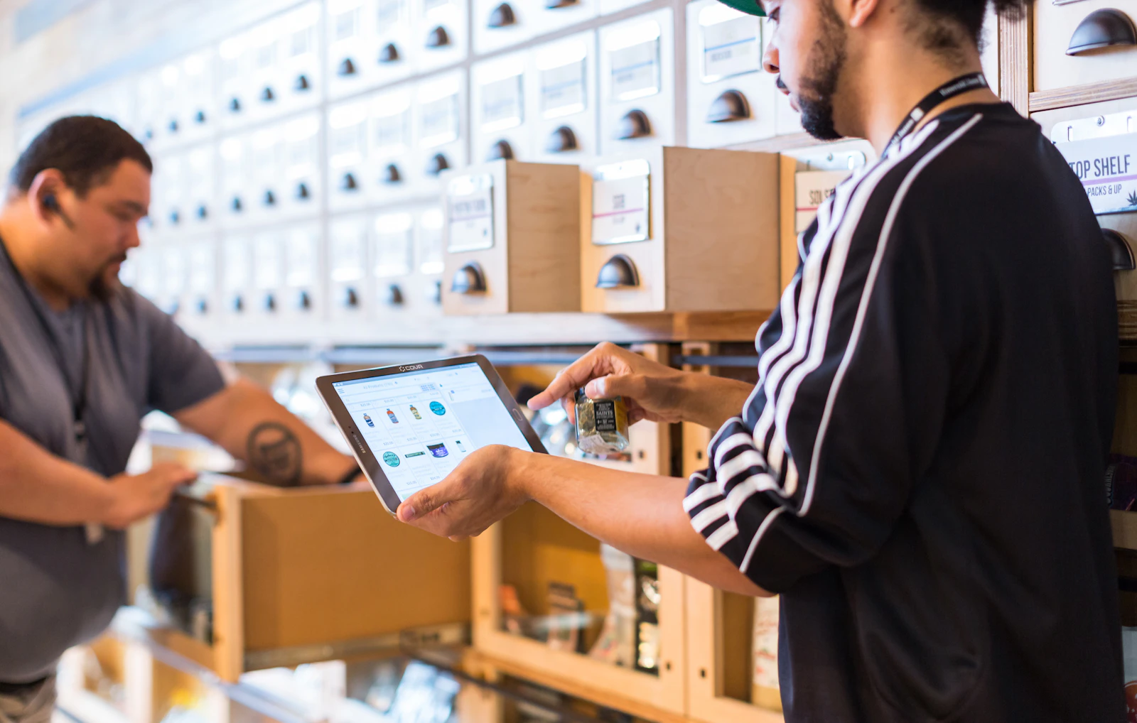 Two business owners reviewing online orders on a tablet